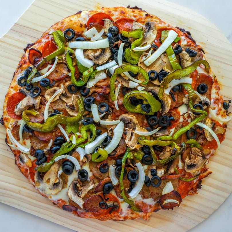 A RigaTony's pizza with pepperoni, sausage, mushrooms, green peppers, onions, and black olives.